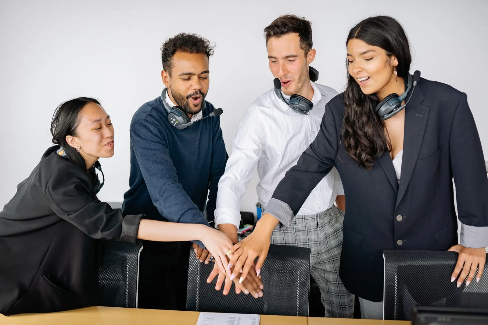 Diverse team putting their hands together in unity