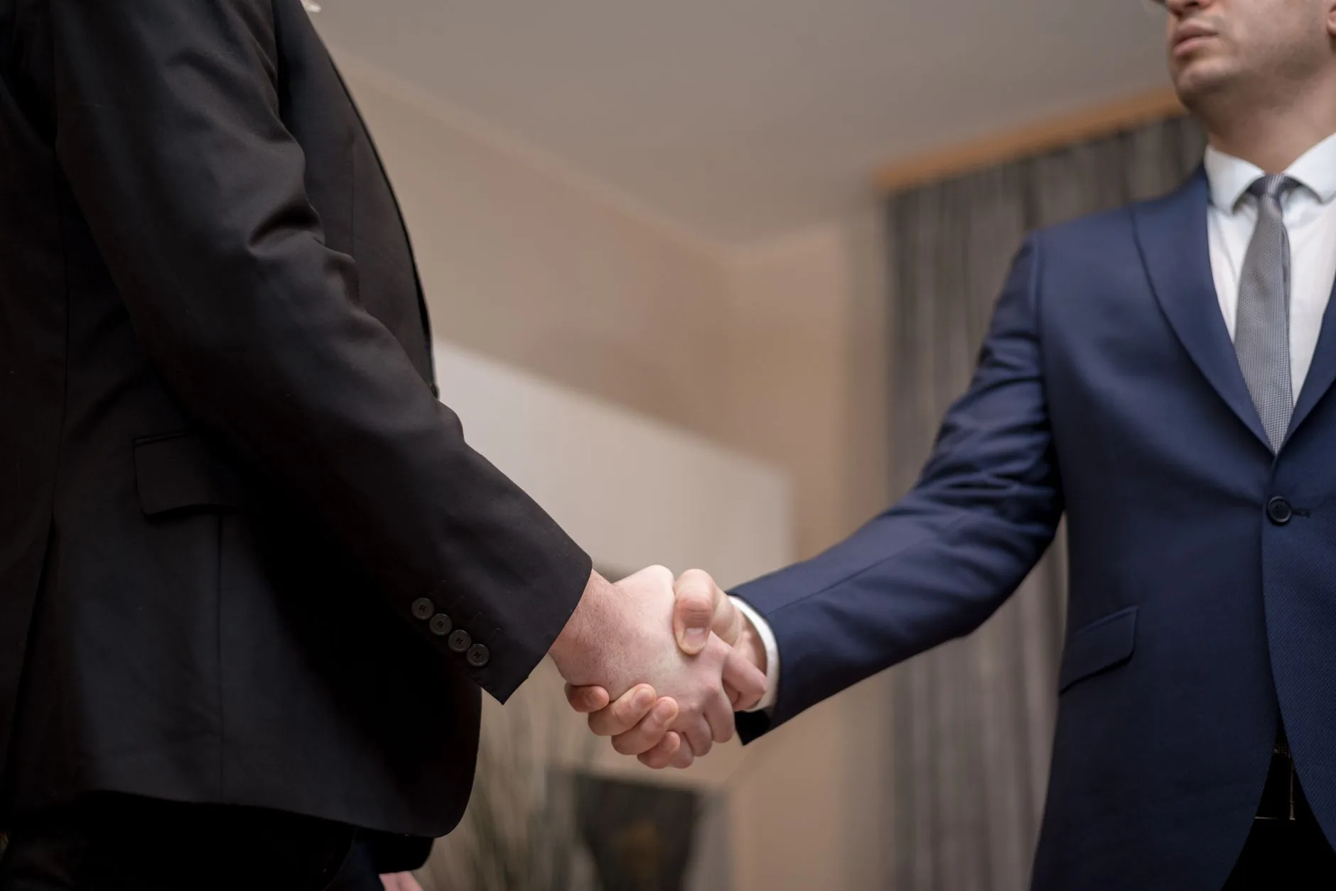 Two businesspeople shaking hands — partnership and trust
