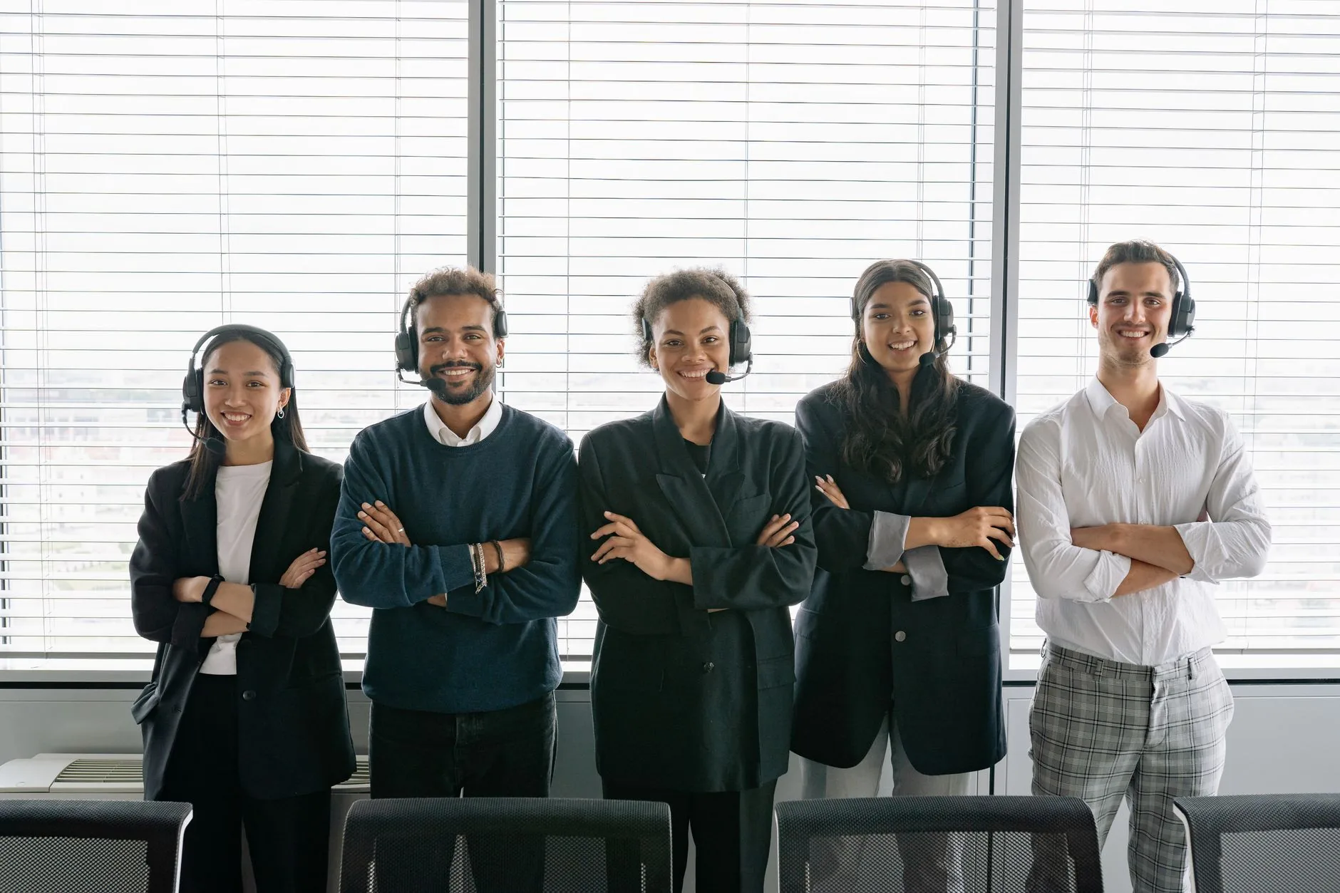 Smiling customer support team wearing headsets